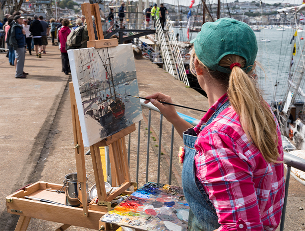 Woman painting Falmouth scene